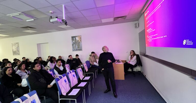 Professor presenting to a group of visiting international students during a lecture session at UNYP