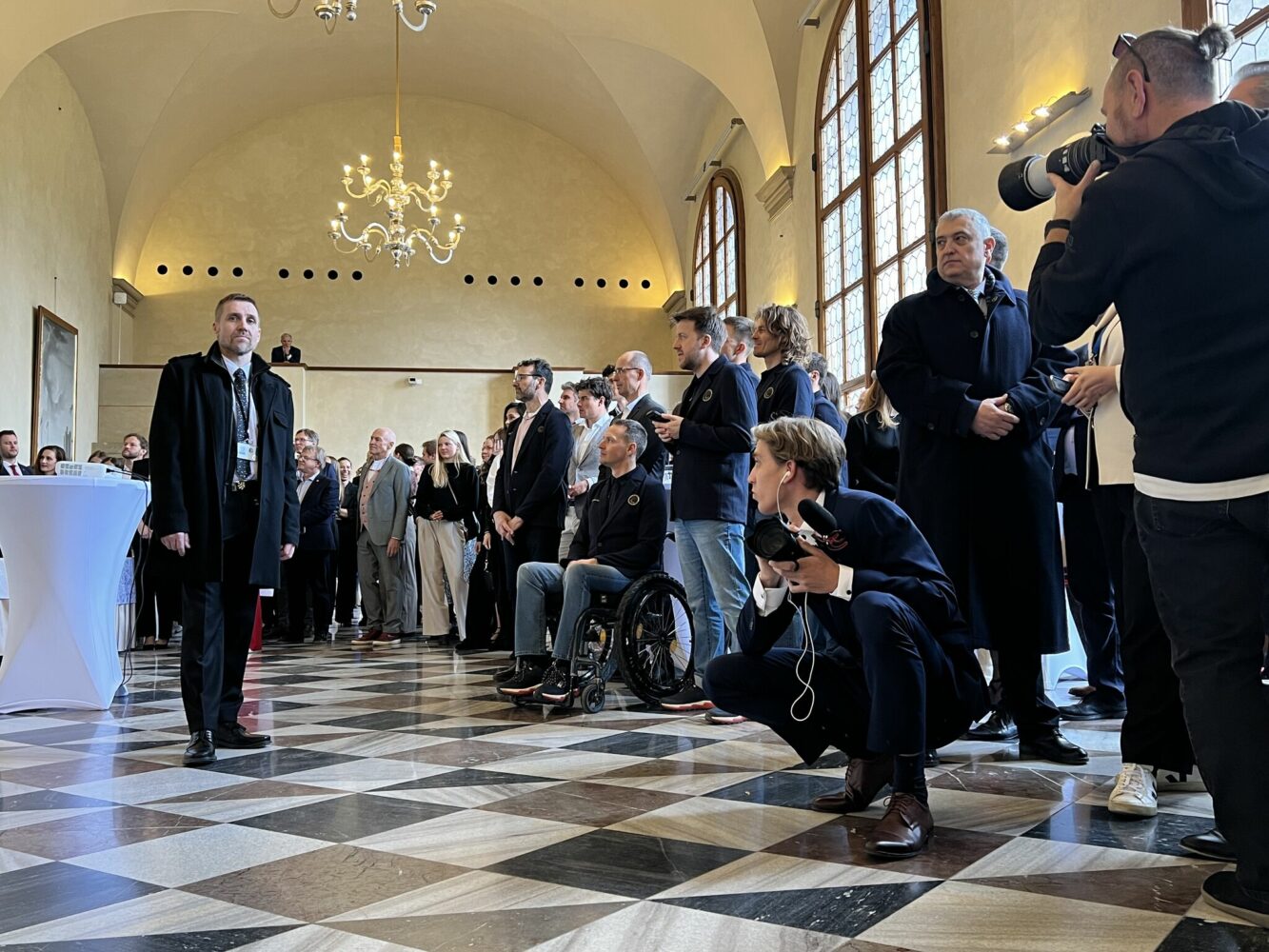 Distinguished guests and photographers watch presentation from the Czech Olympic Team featuring the Czech President